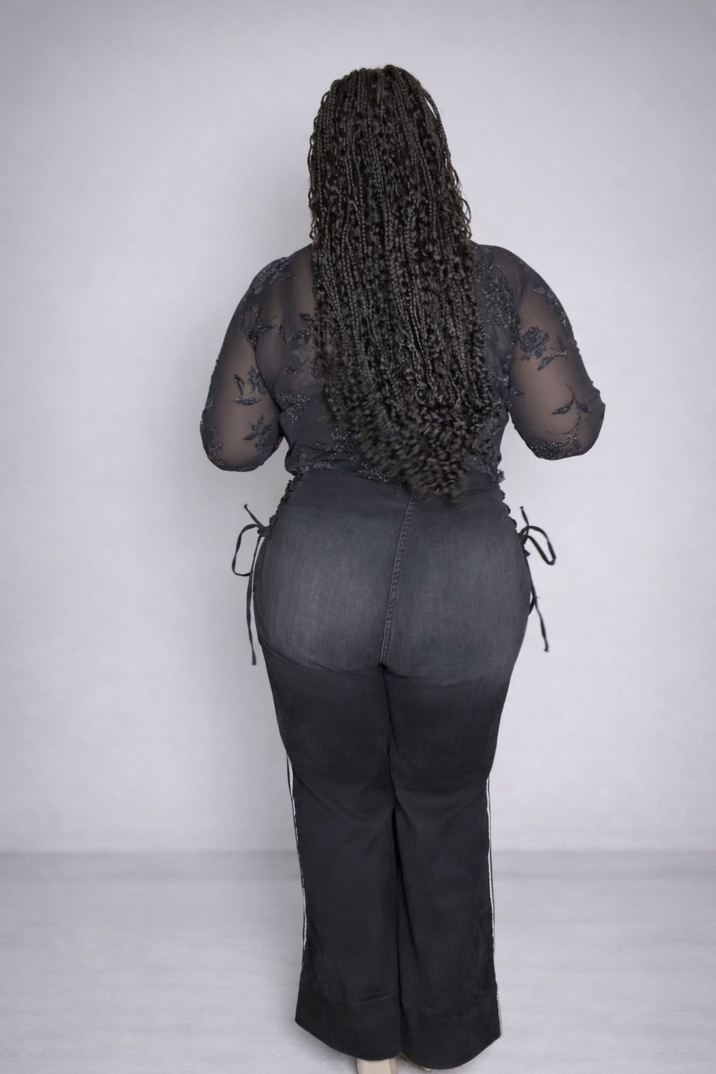 High-waisted black wide-leg jeans featuring
